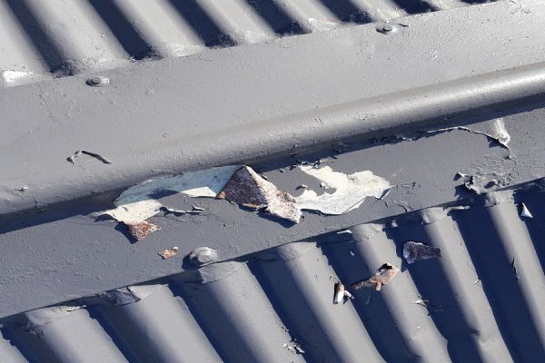 Delamination of aged painted roofing iron